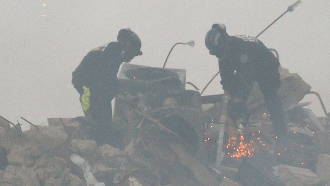 SURFSIDE, FLORIDA - JUNE 25: Members of the South Florida Urban Search and Rescue team look for possible survivors on June 25, 2021 in Surfside, Florida. According to reports, after the collapse of the 12-story Champlain Towers South condo building on June 24, over one hundred people have been reported as missing. Search-and-rescue efforts continue with crews from across Miami-Dade and Broward counties.