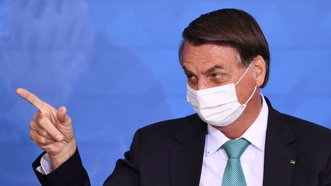  In this file photo taken on June 01, 2021 Brazilian President Jair Bolsonaro gestures during the announcement of sponsorship of the Olympic sports team by the state bank Caixa Economica Federal at the Planalto Palace in Brasilia.
