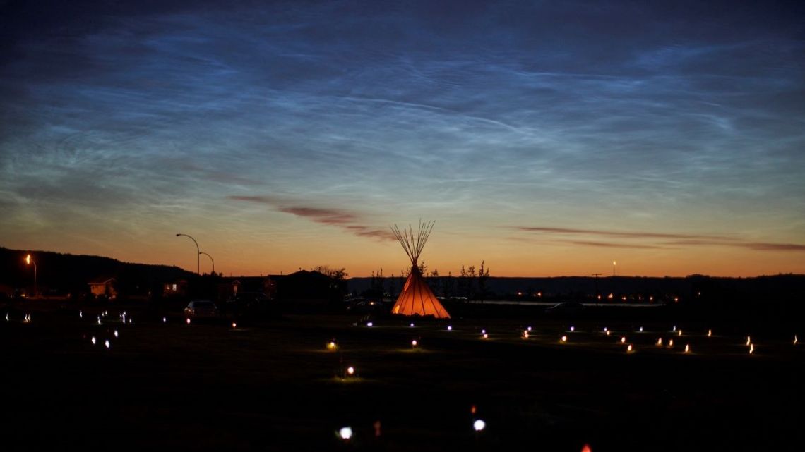 In this file photo solar lights and flags now mark the spots where 751 human remains were recently discovered in unmarked graves at the site of the former Marieval Indian Residential School on the Cowessess First Nation in Saskatchewan on June 27, 2021. 