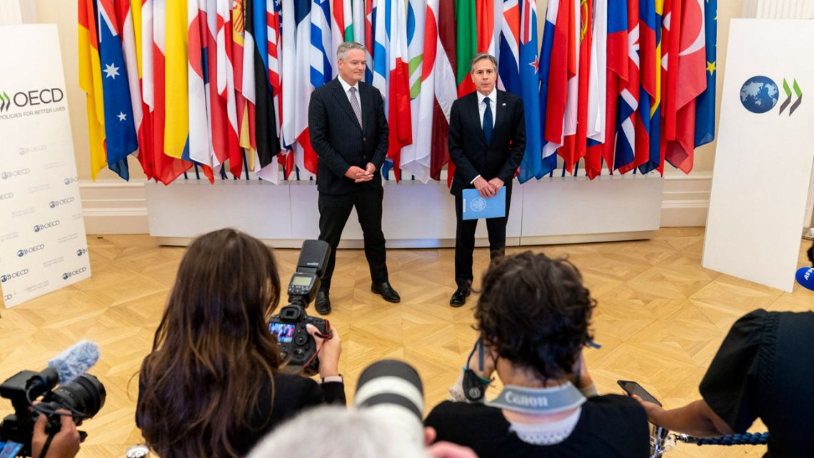 US Secretary of State Antony Blinken (right) speaks to media flanked by Secretary-General of the Organisation for Economic Cooperation and Development (OECD) Mathias Cormann upon his arrival at the OECD headquarters in Paris, on June 25, 2021.