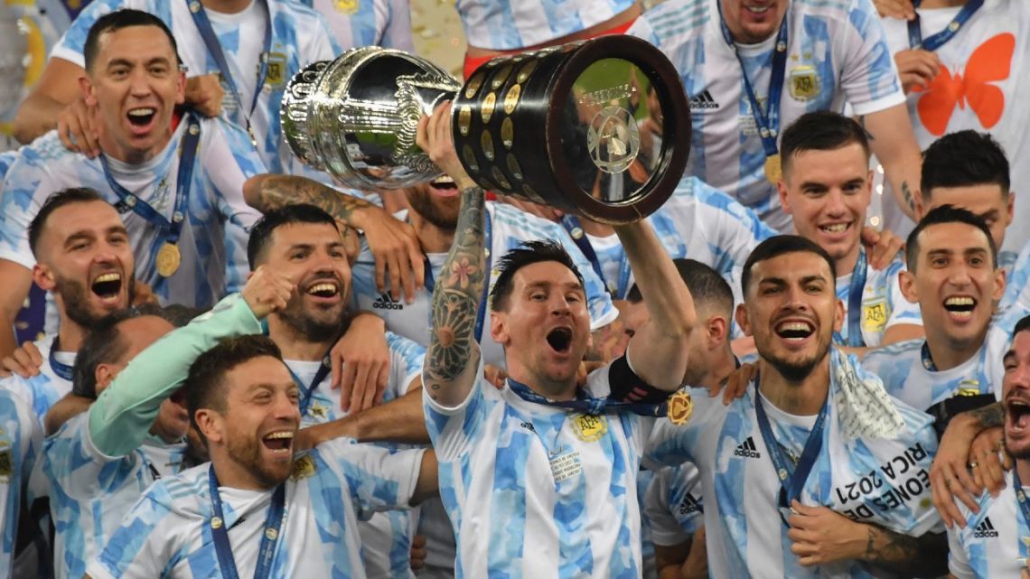 Argentina's Lionel Messi holds the trophy as he celebrates on the podium with teammates after winning the Conmebol 2021 Copa América final against Brazil at Maracanã Stadium in Rio de Janeiro, Brazil, on July 10, 2021. Argentina won 1-0. 