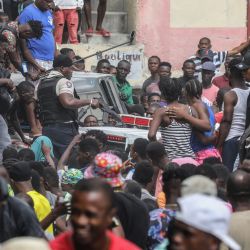 La policía observa cómo dos hombres, acusados de estar involucrados en el asesinato del presidente Jovenel Moise, son transportados a la estación de Petionville en un coche de policía en Puerto Príncipe. | Foto:Valerie Baeriswyl / AFP