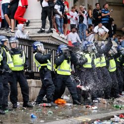 Una fila de policías es el objetivo de los lanzadores de latas de cerveza mientras los seguidores de Inglaterra se sitúan en los alrededores de Trafalgar Square durante la proyección en directo del partido de fútbol de la final de la Eurocopa 2020 entre Inglaterra e Italia en el centro de Londres. | Foto:Tolga Akmen / AFP