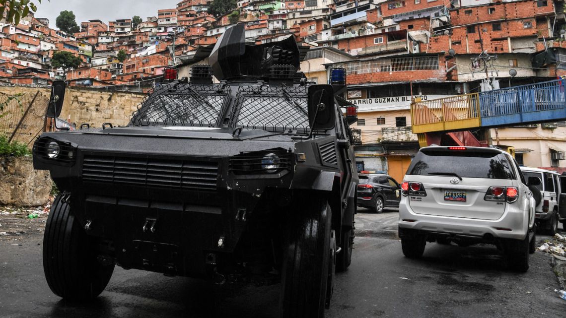 In this photo taken on July 09, 2021, a VN-4 armoured vehicle of a special unit of the national police drives along one of the main streets of the Cota 905 neighbourhood after three days of clashes with alleged members of a criminal gang, in Caracas on July 9, 2021. 