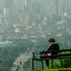 A woman wacthes the view from the Volador hill in Medellín, Colombia, on June 12, 2021. The city has been awarded and recognized for its urban planning of green corridors and is known for its eco-friendly habitat. 