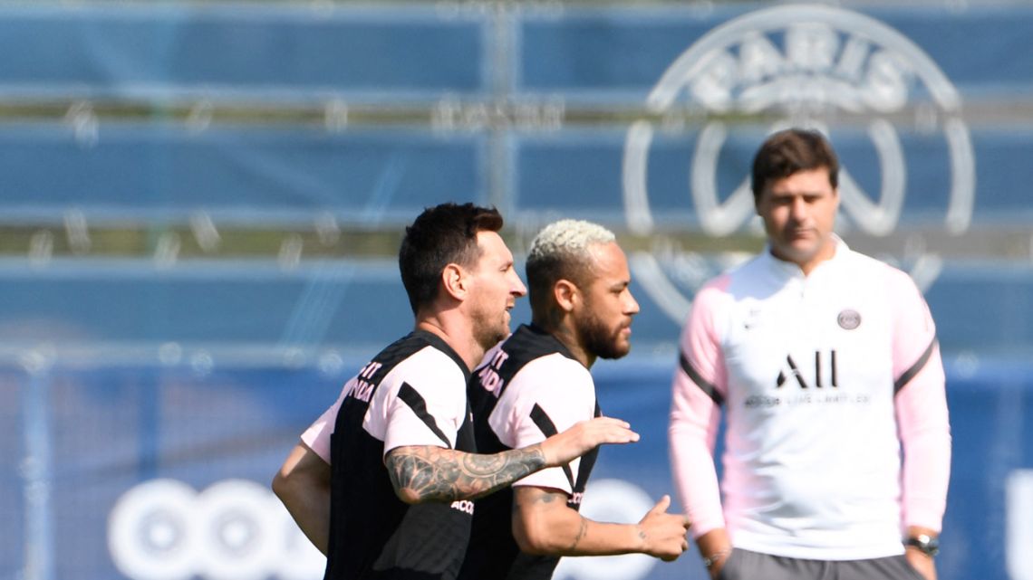 Paris Saint-Germain forwards Lionel Messi (left), Neymar (centre) and the French side's head coach Mauricio Pochettino attend a training session at the Camp des Loges Paris Saint-Germain football club's training ground in Saint-Germain-en-Laye on august 13, 2021.