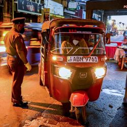 La policía habla con un viajero en un puesto de control durante el bloqueo nacional de diez días impuesto para frenar la propagación del coronavirus Covid-19 en Colombo. | Foto:Ishara S. Kodikara / AFP