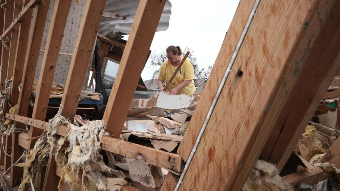 Cheryl Soley Dunpace sorts through her destroyed home in the wake of Hurricane Ida September 1, 2021 in Golden Meadow, Louisiana. Ida made landfall August 29 as a Category 4 storm southwest of New Orleans, causing widespread power outages, flooding and massive damage. 