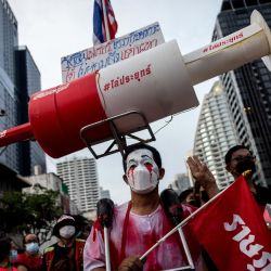 Un manifestante antigubernamental lleva una maqueta gigante de una jeringuilla durante una manifestación en Bangkok, mientras los activistas piden la dimisión del primer ministro de Tailandia, Prayut Chan-O-Cha, por la gestión gubernamental de la crisis del coronavirus Covid-19. | Foto:Jack Taylor / AFP