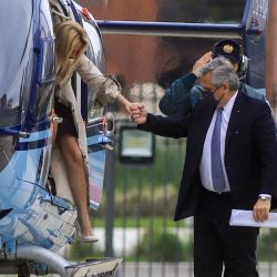 President Alberto Fernández exits a helicopter with First Lady Fabiola Yáñez near the Casa Rosada, the morning after defeat in the PASO primaries.