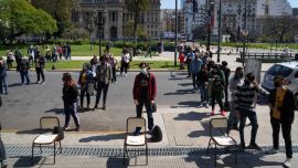 Voters wait in line to cast ballots outside of a polling station during the primary elections in Buenos Aires on Sunday, September 12, 2021.
