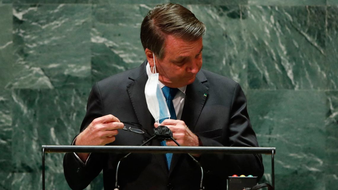Brazil's President Jair Bolsonaro takes off his mask before addressing the 76th Session of the U.N. General Assembly on September 21, 2021 at U.N. headquarters in New York City.