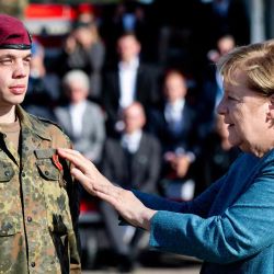 La canciller alemana, AngelaMerkel, premia a un soldado durante un pase de lista militar de la operación de evacuación militar (MilEvakOp), en Seedorf, en el norte de Alemania.  | Foto:AFP