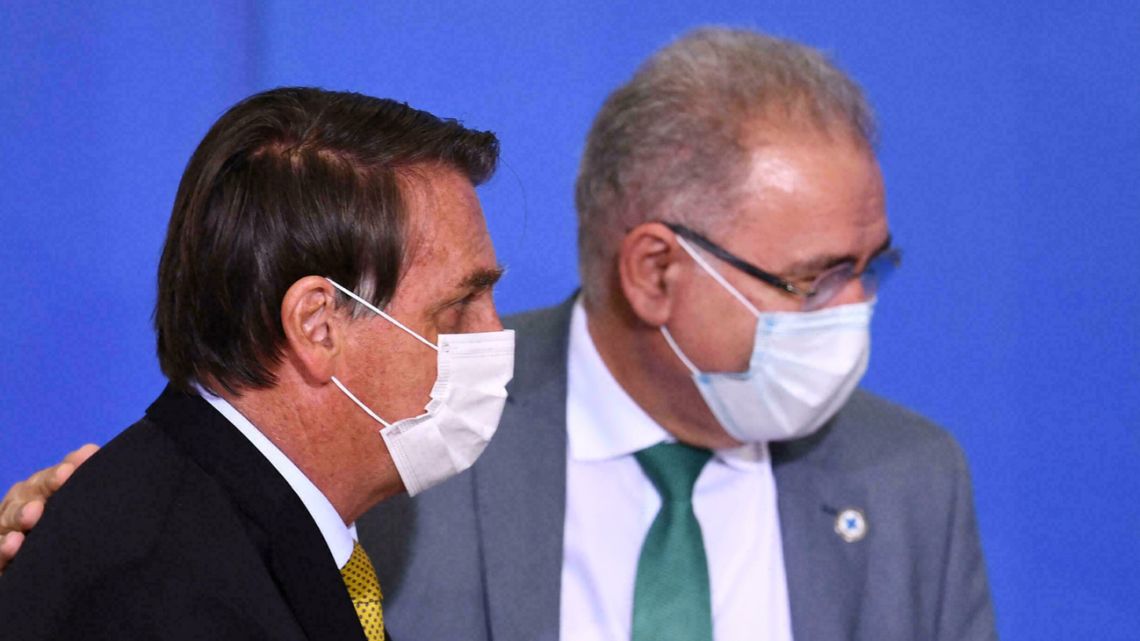Brazil's Health Minister Marcelo Queiroga tested positive for Covid-19 Tuesday after attending the UN General Assembly in New York. The official (in the background) is pictured with President Jair Bolsonaro.