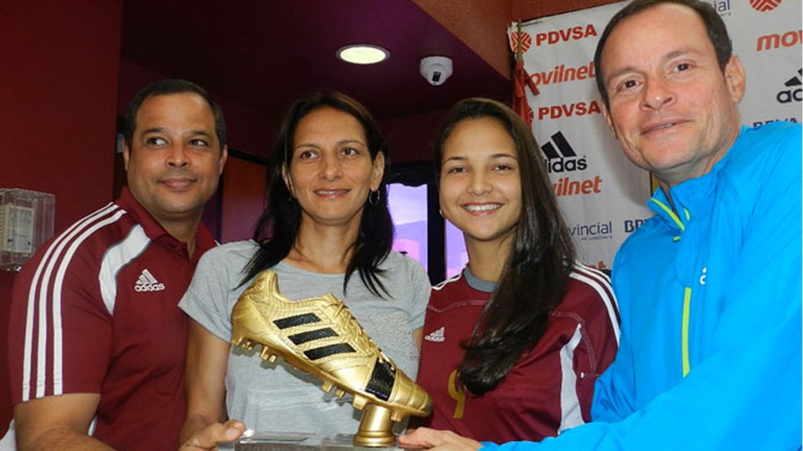 In this 2014 file photo, coach Kenneth Zseremeta (right) awards the under-17 Women's World Cup golden boot to Venezuelan players Deyna Castellanos and Gabriela García.