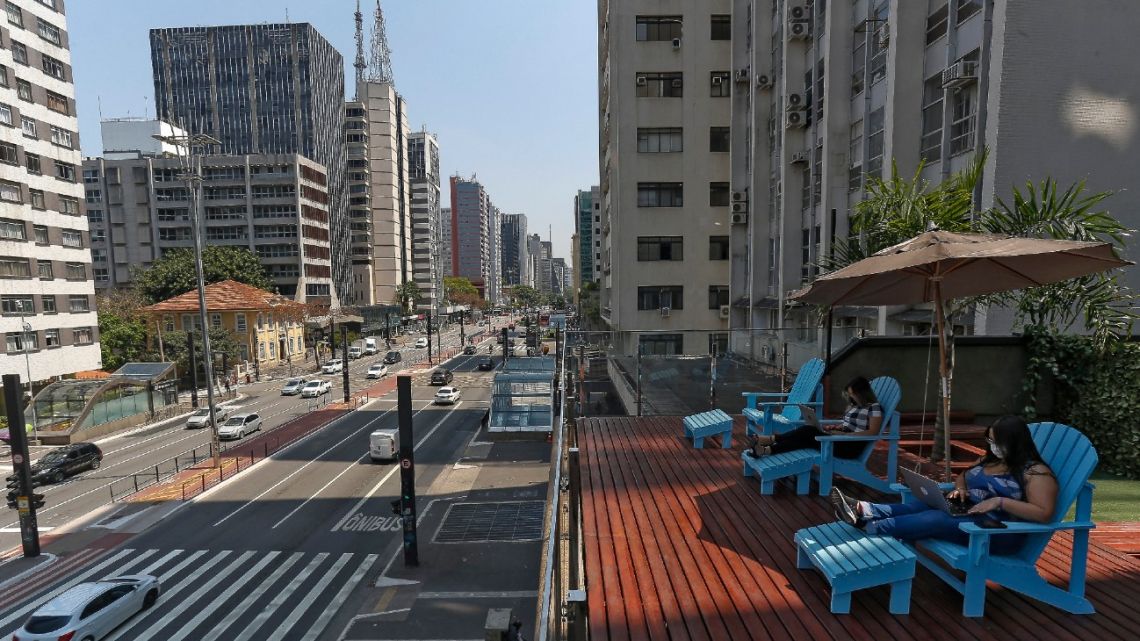 A man works at the terrace of a coworking space over Paulista Avenue, in São Paulo, Brazil, on September 27, 2021