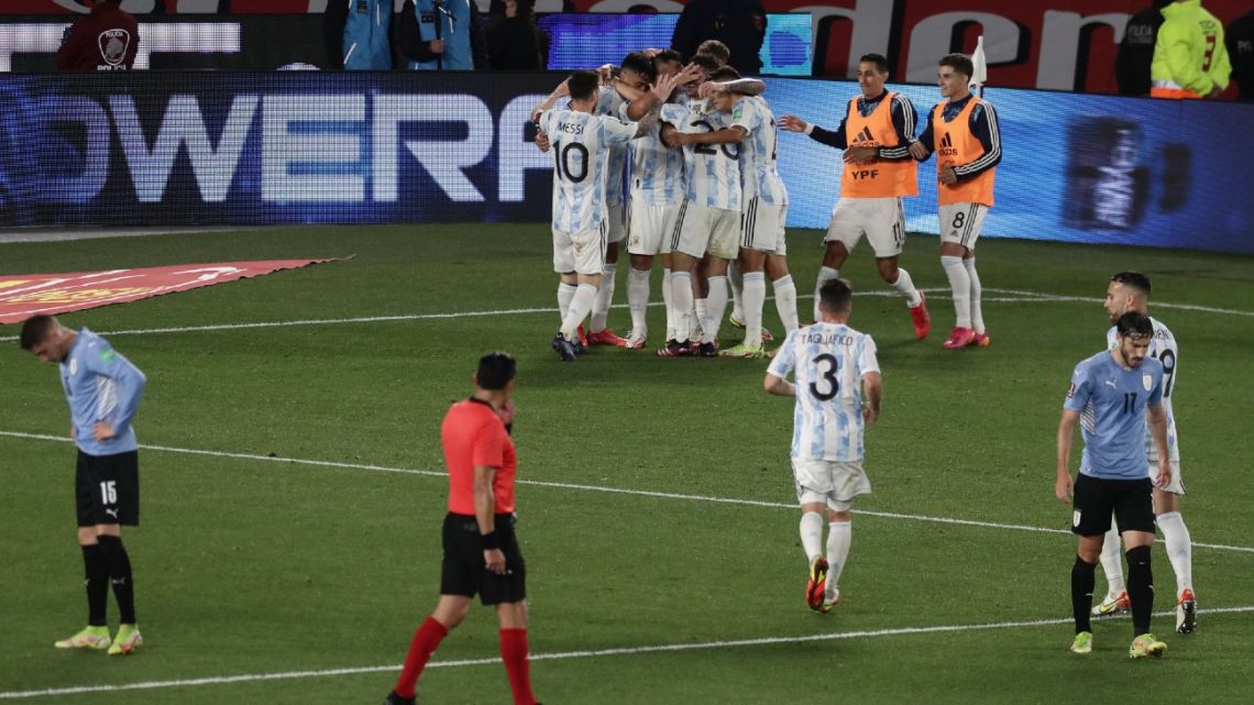 Argentina's players celebrate after scoring against Uruguay during the South American qualification football match for the FIFA World Cup Qatar 2022 at the Monumental stadium in Buenos Aires, on October 10, 2021.