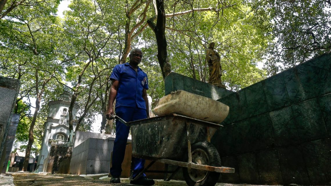 Osmair Camargo Candido, 60, known as Fininho, works as a gravedigger at a cemetery in São Paulo, Brazil, on September 28, 2021. Fininho, who has worked for over 30 years as a gravedigger, is a philosophy teacher, gives vocational courses at a school, and is writing a book.