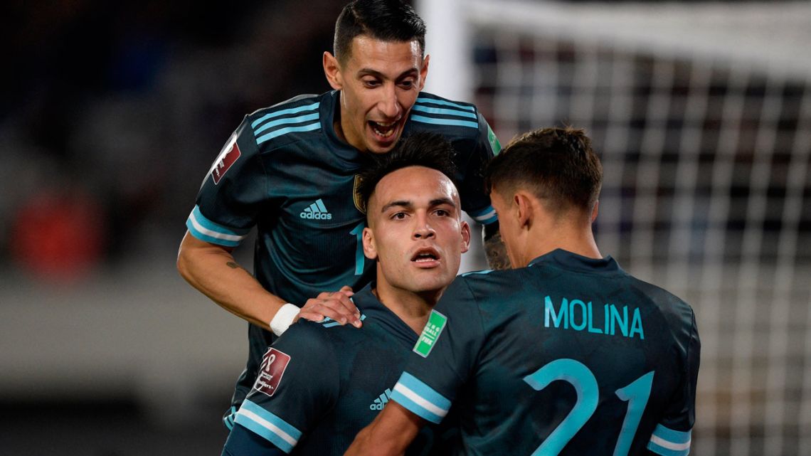 Argentina's Lautaro Martínez celebrates with Ángel Di María and Nahuel Molina after scoring against Peru during the South American qualification football match for the FIFA World Cup Qatar 2022, at the Monumental stadium in Buenos Aires, on October 14, 2021. 