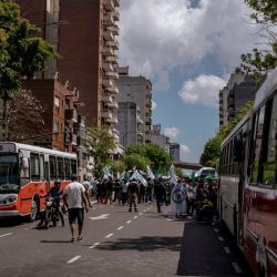 Buses parked near demonstrators marching during a Confederacion General del Trabajo (CGT) union rally in Buenos Aires, Argentina, on Monday, Oct. 18, 2021. 