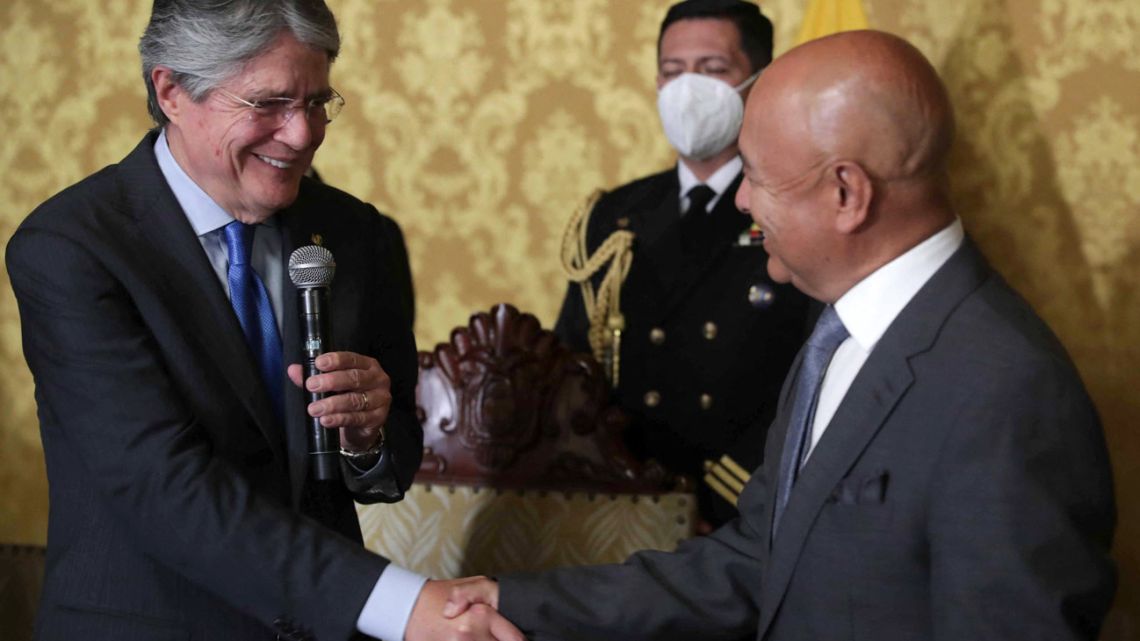 Handout picture released by the Ecuadorean Presidency showing Ecuador's newly appointed Defence Minister, retired general Luis Hernández (right) shaking hands with President Guillermo Lasso after being sworn in, in Quito on October 18, 2021. 