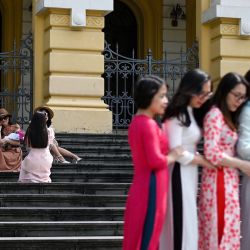 Unas mujeres posan para fotografiarse en el exterior de la Ópera de Hanoi, para conmemorar el Día de la Mujer Vietnamita. | Foto:MANAN VATSYAYANA / AFP