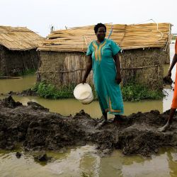 Un grupo de personas construye presas en el campamento inundado de Dibba Busin para refugiados sursudaneses en el estado sudanés de Nilo Blanco. | Foto:ASHRAF SHAZLY / AFP