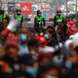 Policías montados son vistos durante una protesta de simpatizantes del partido de izquierda Perú Libre exigiendo al presidente Pedro Castillo que cierre el Congreso unicameral, en el centro de Lima. | Foto:Gian Masko / AFP