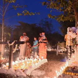 Los devotos cristianos ofrecen oraciones en las tumbas de sus familiares para celebrar el Día de Todos los Santos en un cementerio de Calcuta. | Foto:DIBYANGSHU SARKAR / AFP