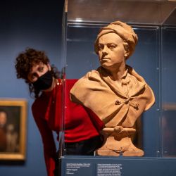 Una asistente de la galería posa con un busto del artista inglés William Hogarth realizado por el artista francés Louis Francois Roubiliac durante un photocall para la exposición Hogarth y Europa en la Tate Britain en Londres. | Foto:Tolga Akmen / AFP