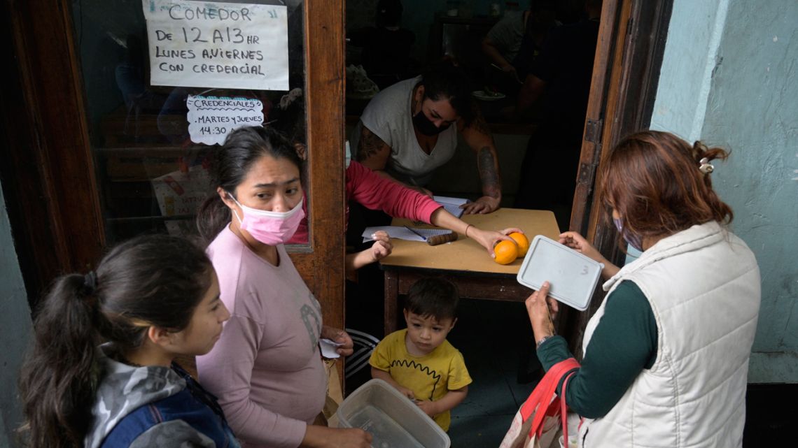 People receive a free meal at a community kitchen of the MRP (Movimiento Resistencia Popular) in La Boca neighbourhood, Buenos Aires, Argentina, on November 2, 2021.