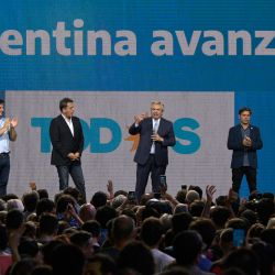 President Alberto Fernández (centre), flanked by Buenos Aires Province Governor Axel Kicillof, lawmaker Máximo Kirchner, lawmaker-elect Victoria Tolosa Paz, Lower House Speaker Sergio Massa, lawmaker-elect Leandro Santoro (2-L) and Gisela Marziotta of the ruling Frente de Todos coalition are seen with supporters after the midterm elections in Buenos Aires, on November 14, 2021.