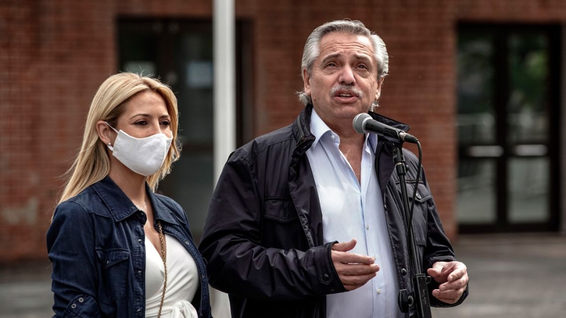 President Alberto Fernández, accompanied by First Lady Fabiola Yáñez, speaks to members of the media after casting a ballot during the midterm elections in Buenos Aires on November 14.