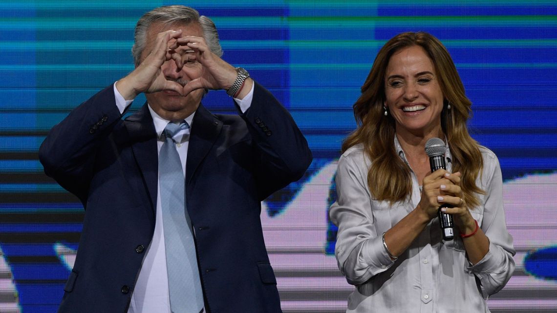 President Alberto Fernandez makes a heart symbol to supporters next to legislator-elect Victoria Tolosa Paz onstage, after the midterm elections on November 14, 2021. 