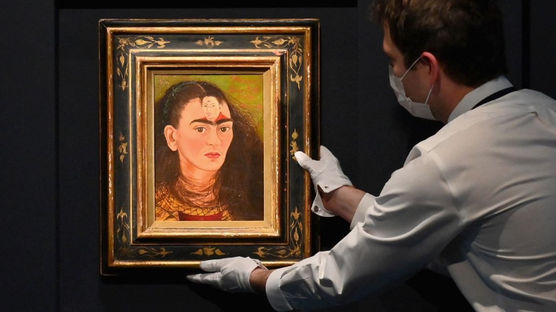 An art handler adjusts Frida Kahlo's final bust self-portrait 'Diego y yo' at Sotheby's on November 5, 2021 in New York City. 