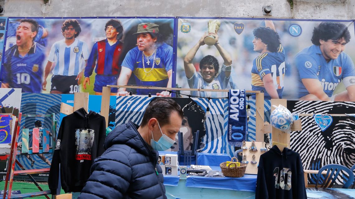 A stand by posters in homage to Diego Maradona is pictured at the so-called "Maradona square" in the Quartieri Spagnoli district of Naples on November 23, 2021. 