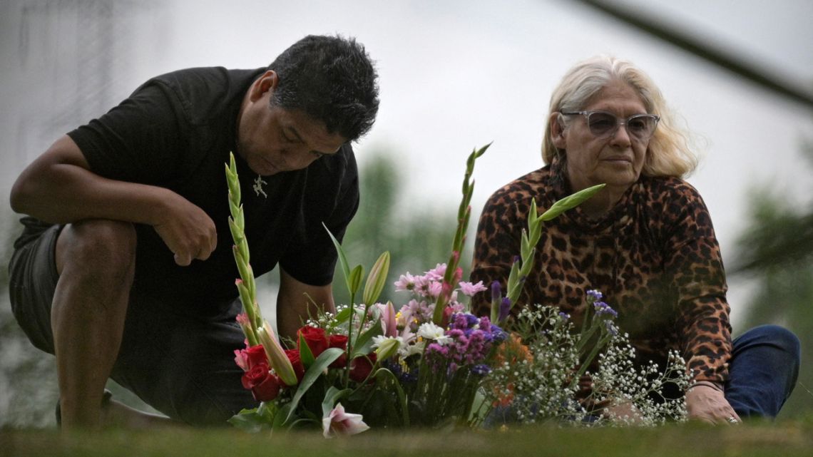 Raúl Maradona (left) and Claudia Maradona, brother and sister of late footballer Diego Maradona, visit his grave on the first anniversary of his death in Bella Vista, Buenos Aires Province on November 25, 2021.