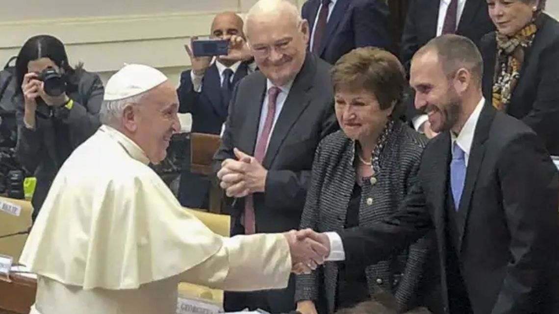 Pope Francis shakes hands with Economy Minister Martín Guzmán at the Vatican in February 2020, as IMF Managing Director Kristalina Georgieva looks on.