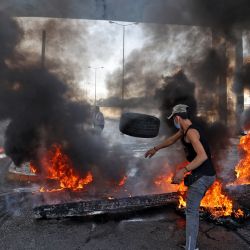 Manifestantes libaneses bloquean una carretera con neumáticos en llamas durante una protesta en la capital, Beirut, mientras el país lucha contra una profunda crisis económica. | Foto:Anwar Amro / AFP