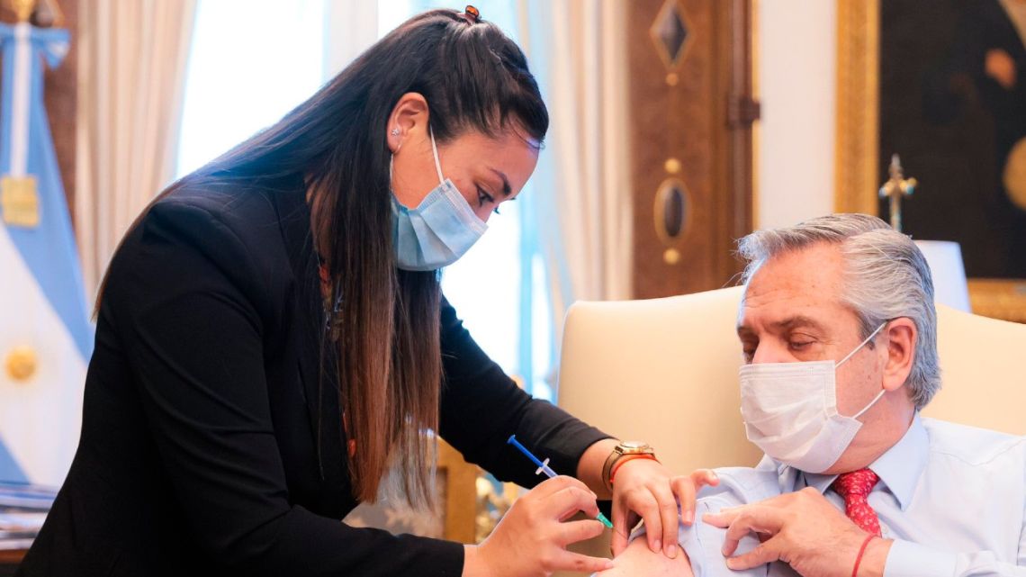 Argentina's President Alberto Fernández receives a third shot of coronavirus vaccine at the Casa Rosada on December 6, 2021.