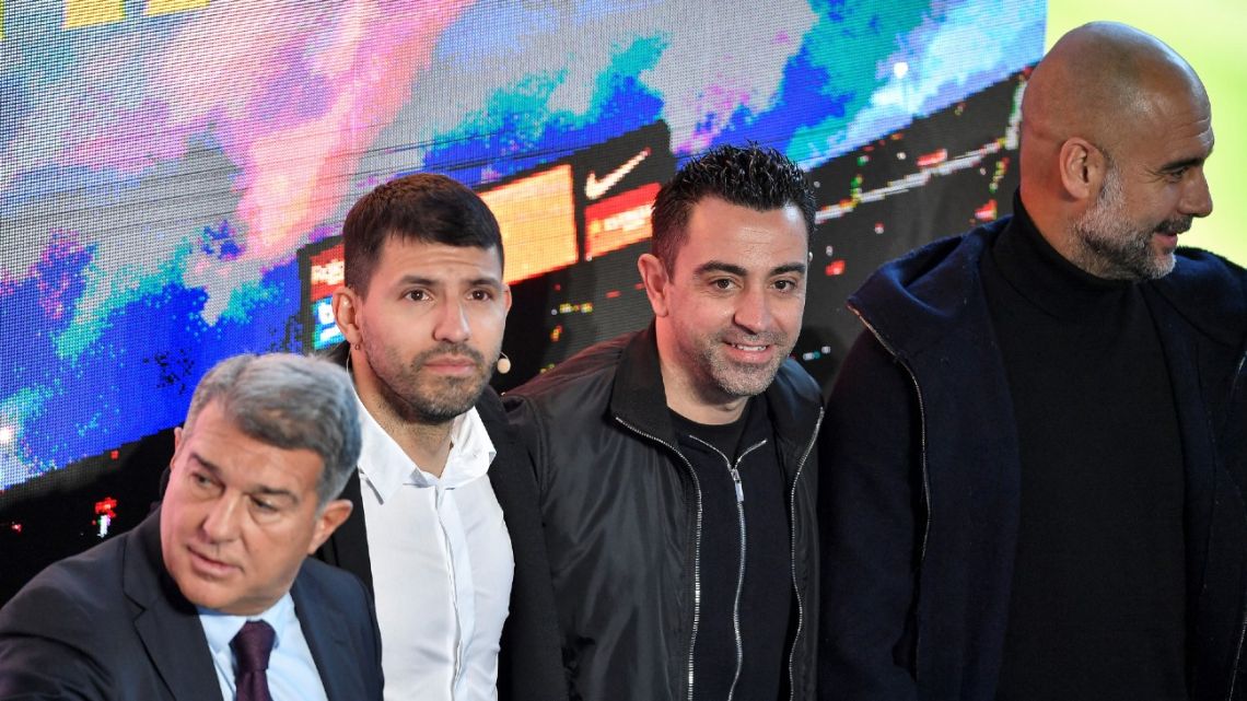 Sergio 'Kun' Agüero poses for a picture with Barcelona Club President Joan Laporta, first team coach Xavi and former Barcelona player, coach and current Manchester City head coach Pep Guardiola during a press conference to announce his retirement from football, at the Camp Nou stadium in Barcelona, on December 15, 2021.