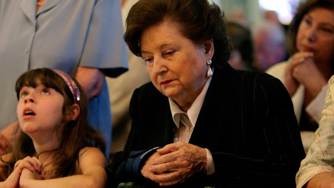 In this file photo taken on December 11, 2007, the widow of the late Chilean dictator (1973-1990) Augusto Pinochet, Lucia Hiriart (centre), hears mass at the military church in Santiago, in the first anniversary of Pinochet's death. 