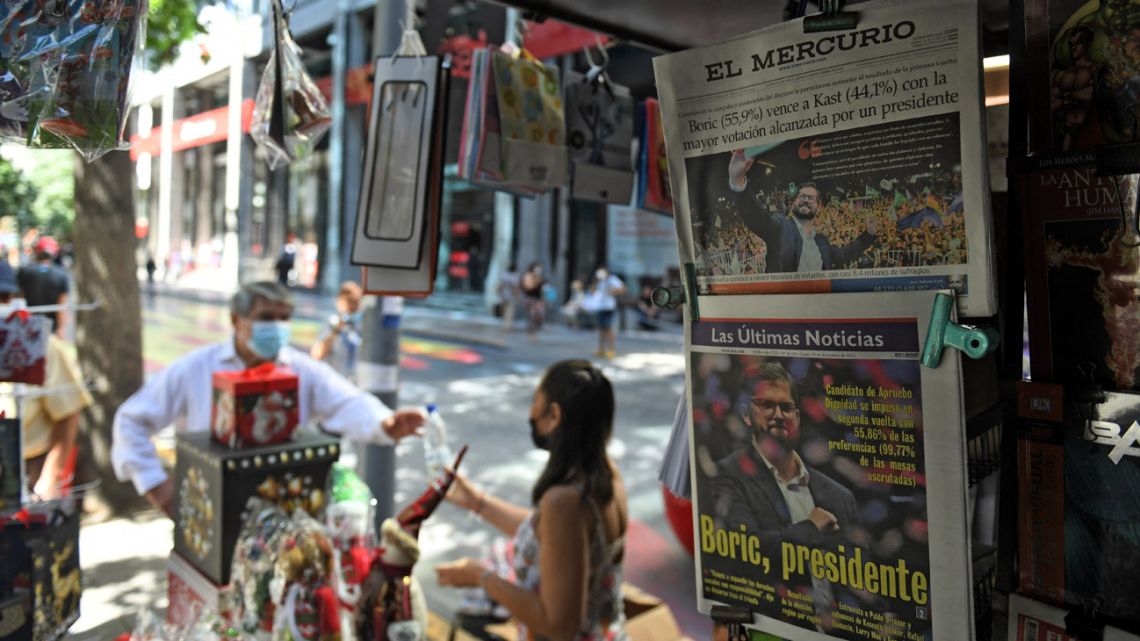 View of newspaper front pages depicting Chilean president-elect Gabriel Boric at a newsstand in downtown Santiago, on December 20, 2021, the day after the presidential runoff election in Chile. 