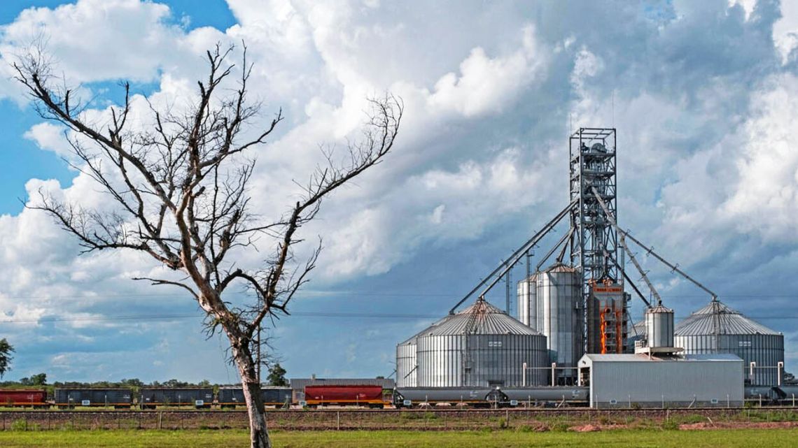 A cargo train that runs alongside the National Route 16 highway collects grains from a silo, Chaco Province.