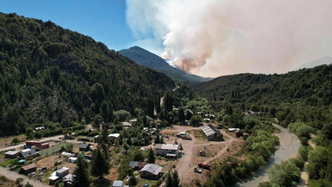 Smoke billows from a huge forest fire seen from the village of Paraje, Río Negro Province, 70 km south of Bariloche, Argentina, on December 24, 2021. 