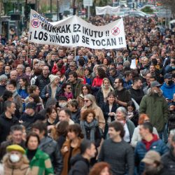 Manifestantes sostienen una pancarta en la que se lee "no tocar a los niños", durante una manifestación convocada por la asociación "Bizitza" (Vida), para protestar contra el pase sanitario y las vacunas Covid-19 para niños, en la ciudad vasca española de San Sebastián. | Foto:ANDER GILLENEA / AFP
