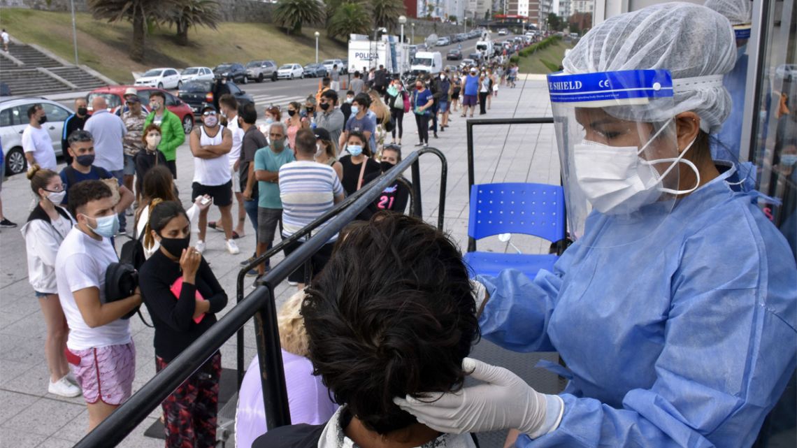 A long line of people wait to take a Covid test outside a Buenos Aires Province government mobile testing unit near Playa Grande in Mar del Plata.