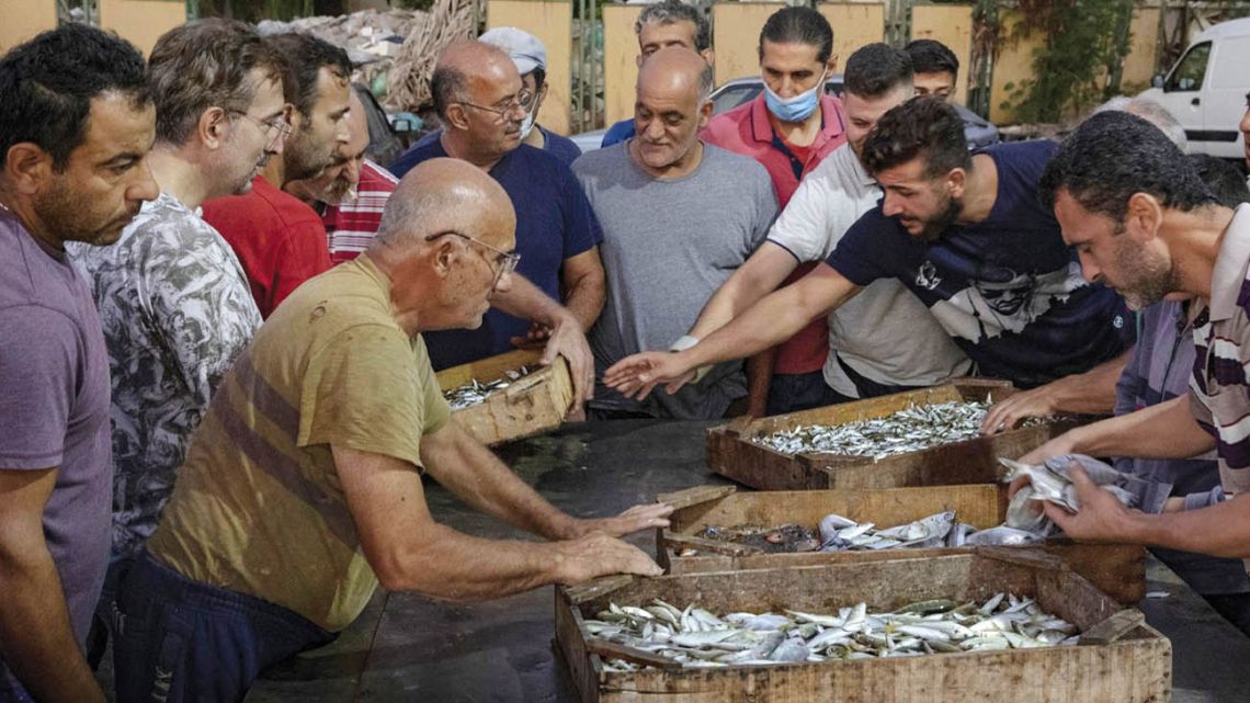 Buyers negotiate at a fish market in Beirut.