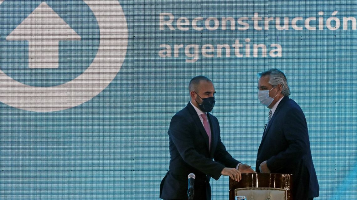 President Alberto Fernández (right) and Economy Minister Martín Guzmán get ready for a conference to give details about the proposed payment to the International Monetary Fund (IMF) for the debt restructuring, to provincial governors, government officials, and businessmen, in Buenos Aires, on January 5, 2022. 