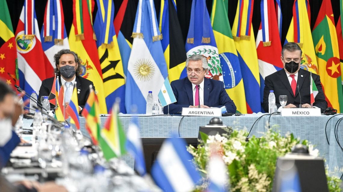 Handout picture released by the Presidency shows President Alberto Fernández (centre) delivering a speech (flanked by Foreign Minister Santiago Cafiero and Mexican Foreign Minister Marcelo Ebrard) during the XXII Ministerial Meeting of the Community of Latin American and Caribbean States (CELAC), in Buenos Aires, on January 7, 2022.